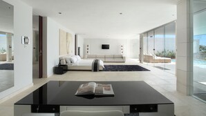 A modern bedroom with a large bed, a flat-screen TV, and a view of a swimming pool. - C151 Dreamland (Pecatu)