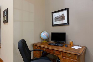 A wooden desk with a globe, a computer monitor, and a keyboard. - Super 8 by Wyndham Lake of the Ozarks (Eldon)