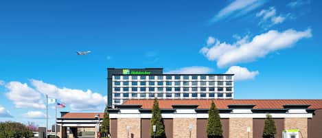 A Holiday Inn Express hotel with a parking lot and a fuel pump.