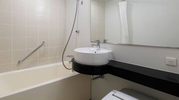 A modern bathroom with a bathtub, a sink, a toilet, and a shower.