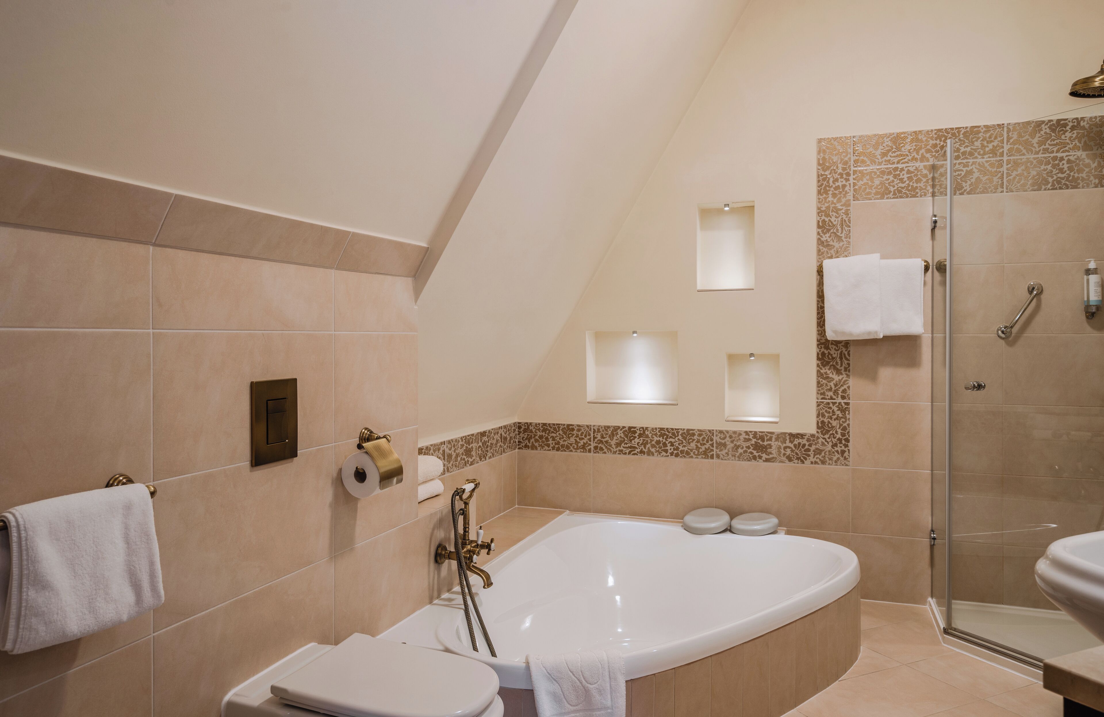 A modern bathroom with a freestanding bathtub, a glass-enclosed shower, and a toilet.