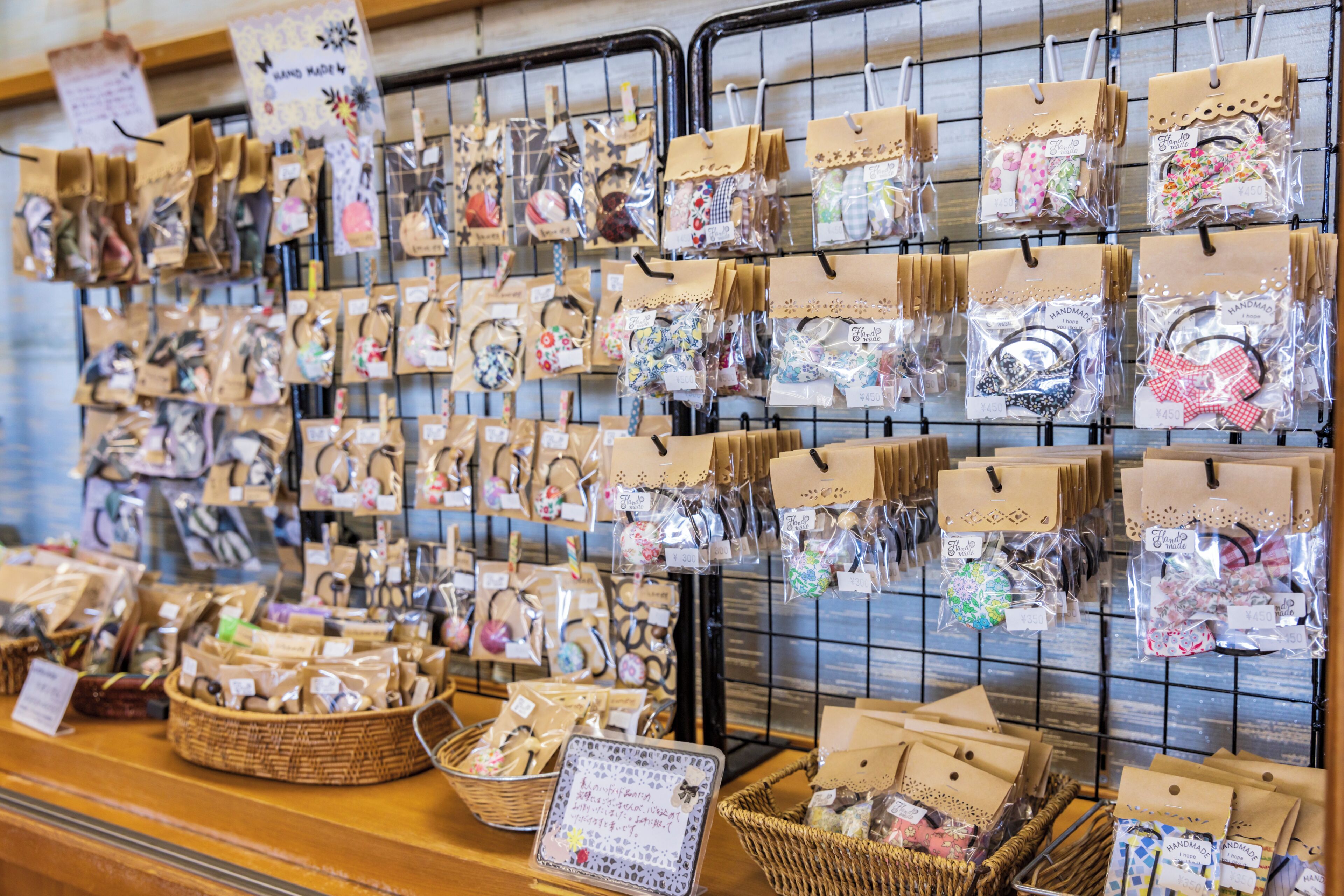 A display of handmade items with price tags in a store.
