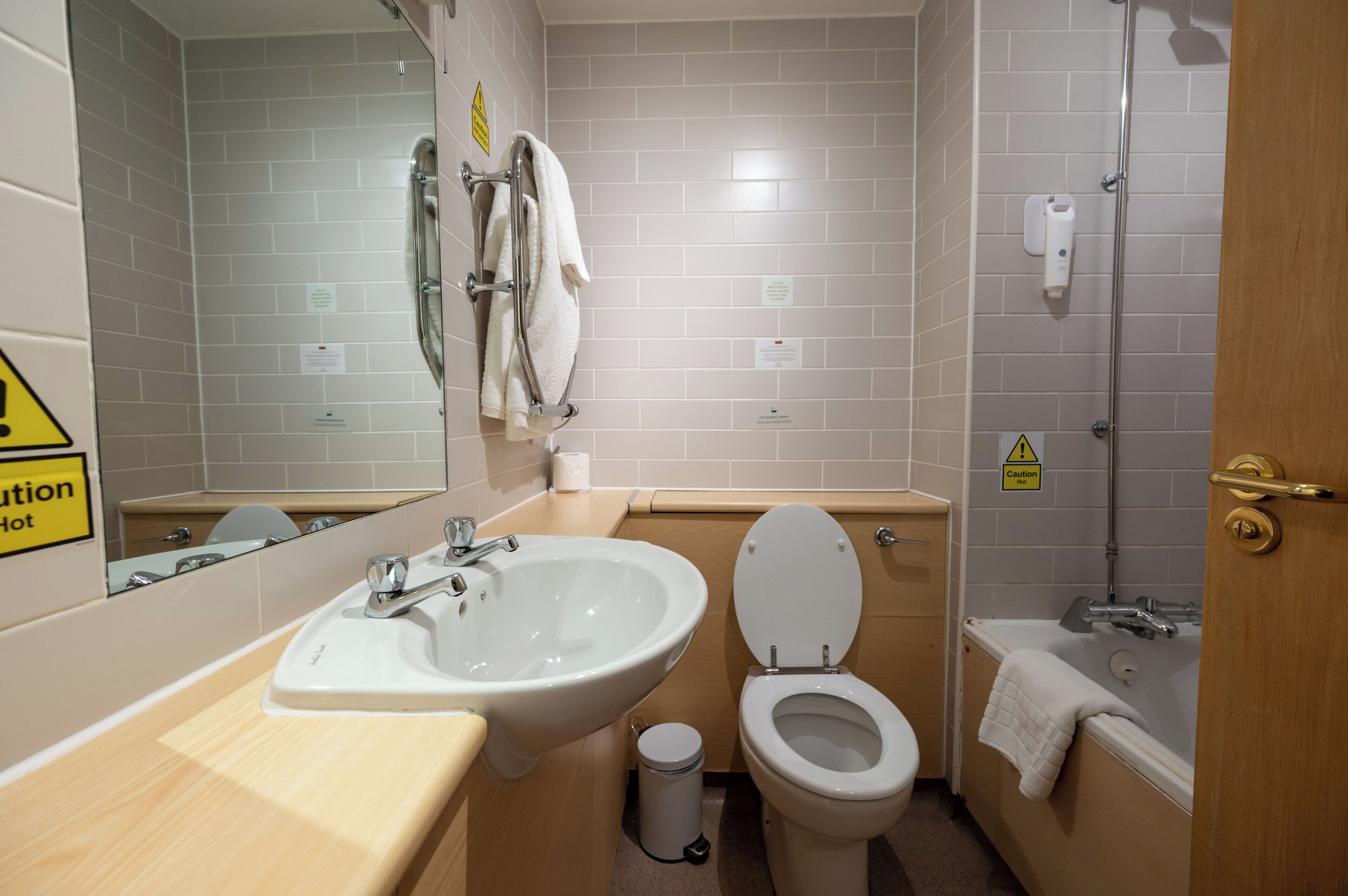 A bathroom with a sink, toilet, and bathtub.
