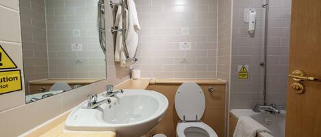A bathroom with a sink, toilet, and bathtub.