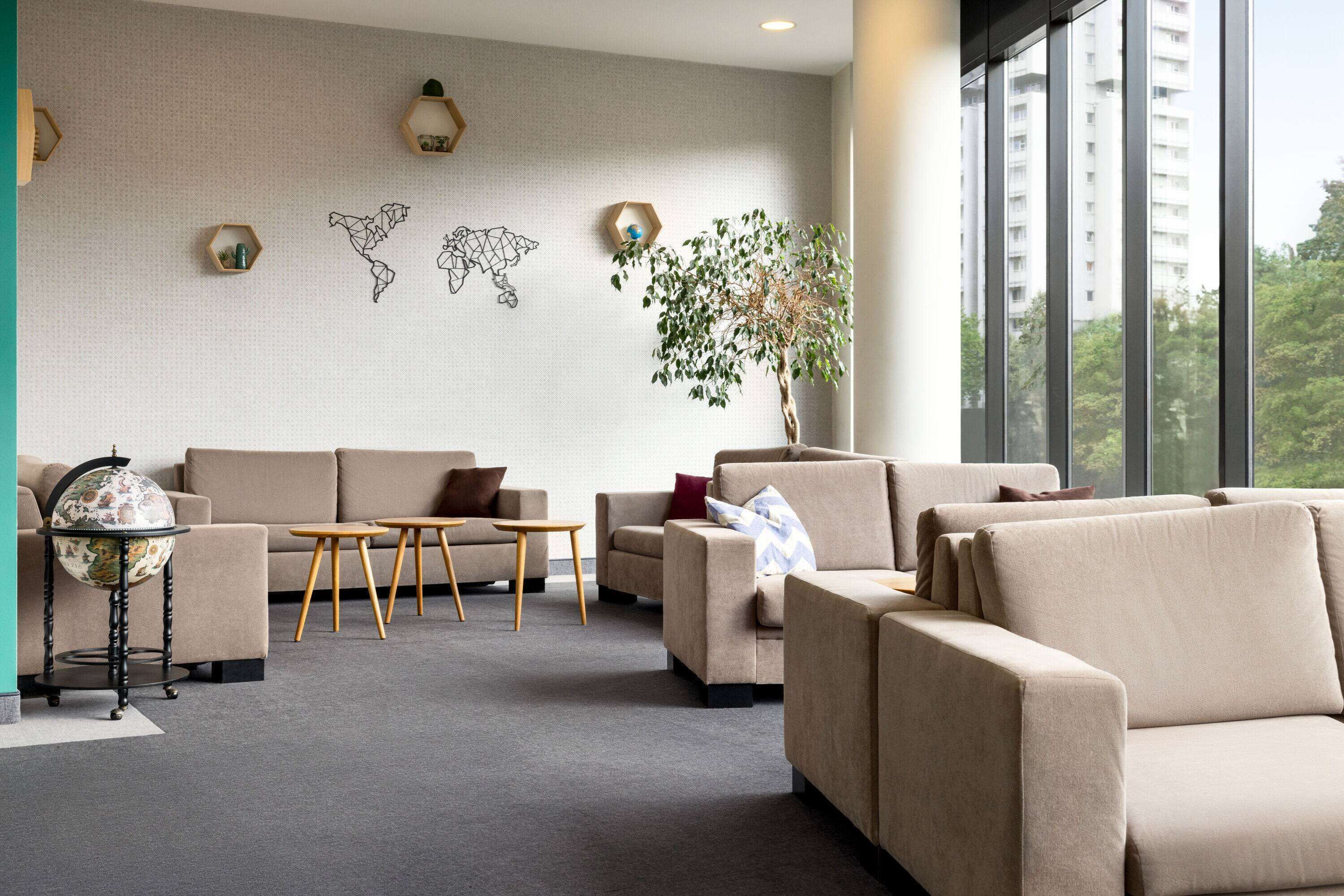 A modern living room with a sofa set, a coffee table, and a globe on a stand.