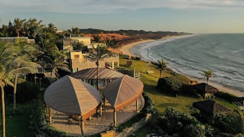 Enjoy a serene beachside escape with a view of the ocean from this resort's beautifully landscaped lawn and palm trees.
