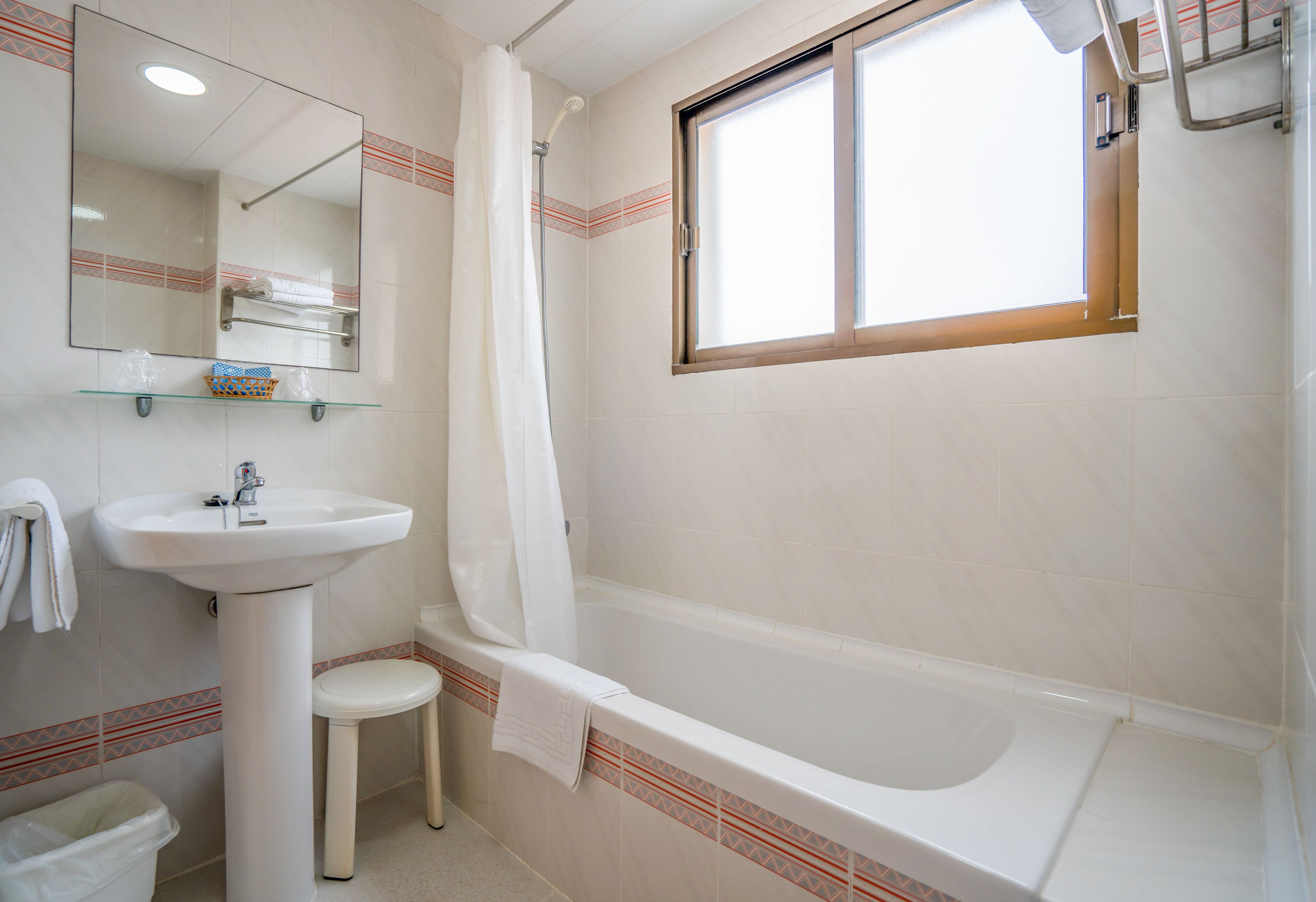 A bathroom with a sink, toilet, and bathtub.