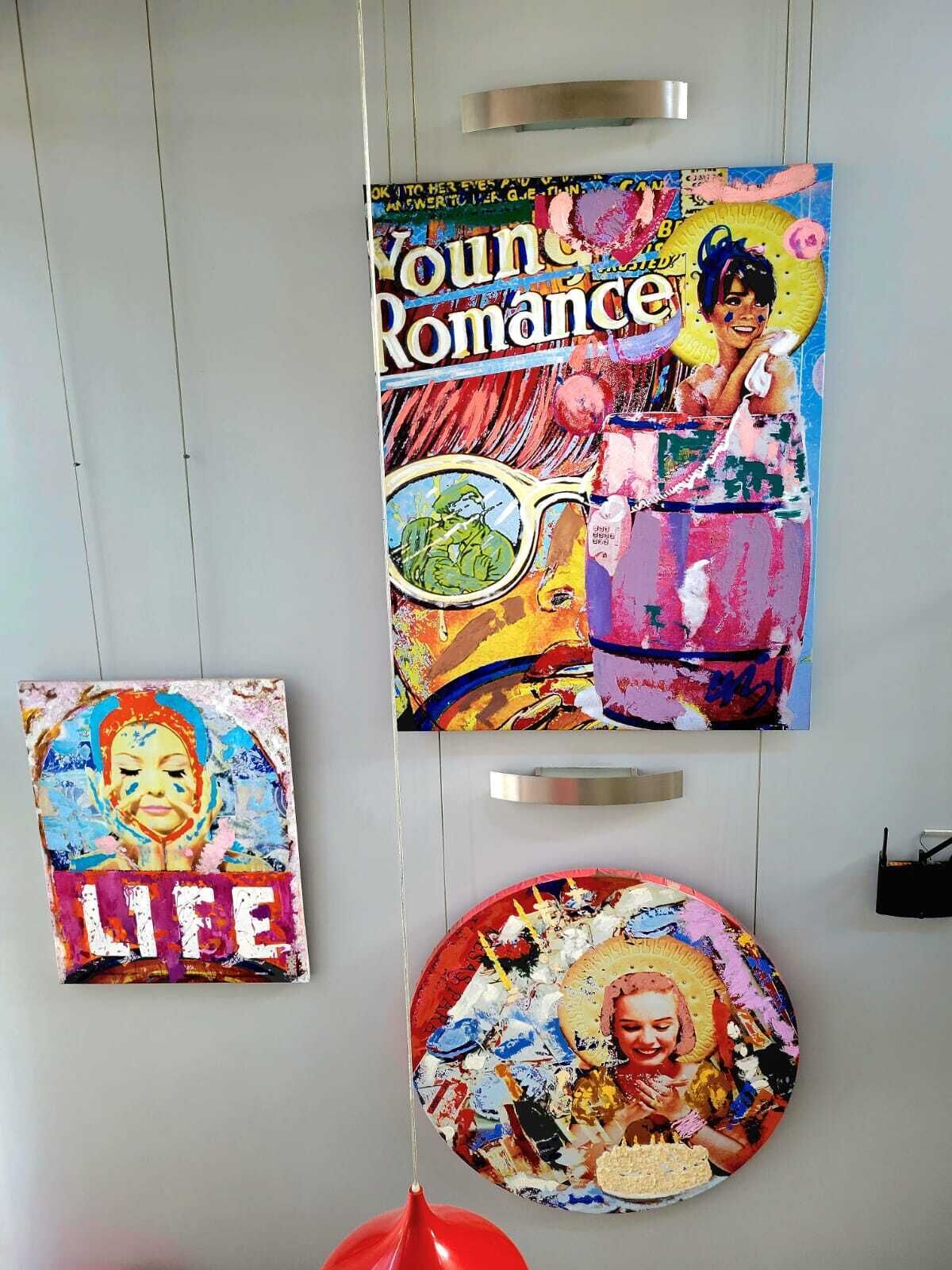 Three artworks on a wall.