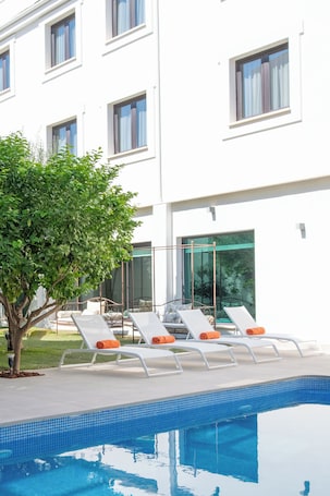 Seasonal outdoor pool, open 8:00 AM to 9:00 PM, pool umbrellas