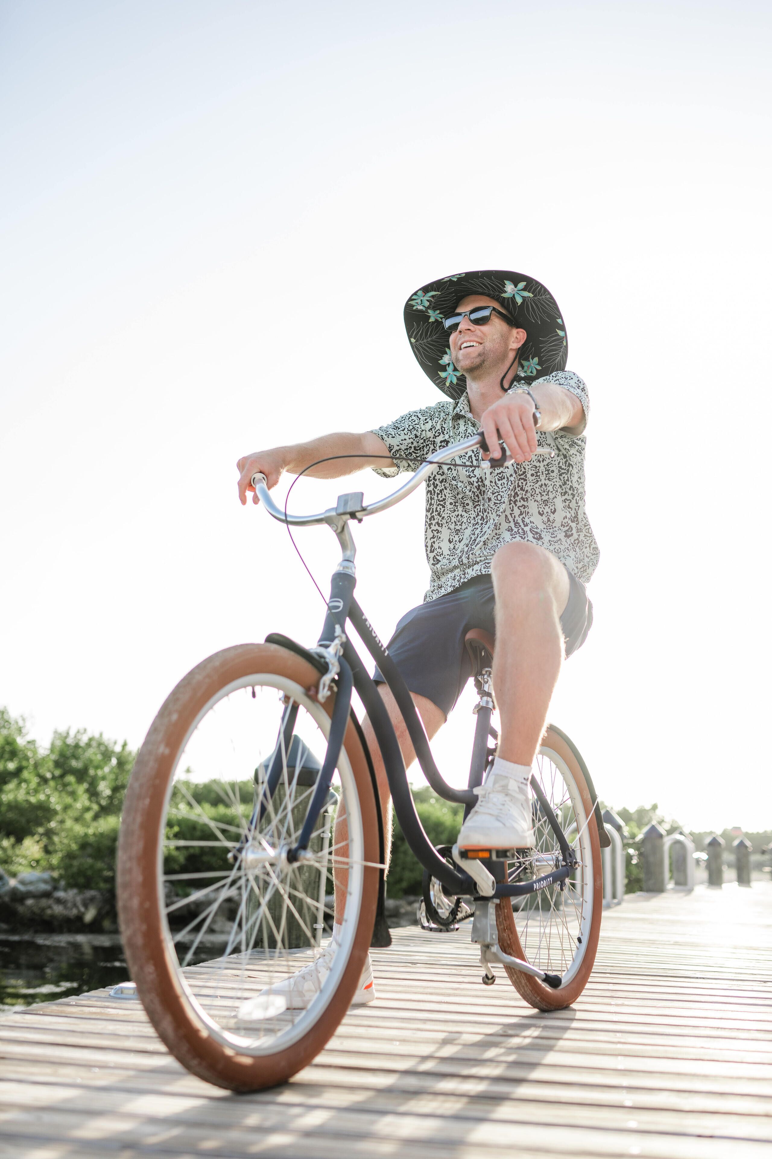 A person riding a bicycle on a wooden bridge.