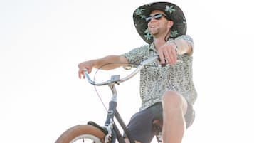 A person riding a bicycle on a wooden bridge.