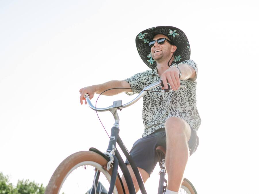 A person riding a bicycle on a wooden bridge.