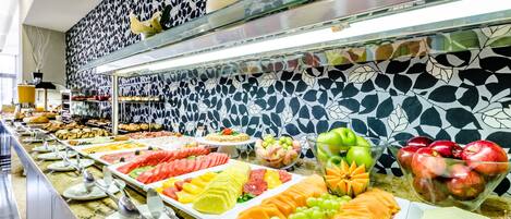A buffet with various fruits and vegetables.