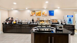 A modern kitchen with a buffet setup, including a coffee station, a microwave, and various food items. - Comfort Inn & Suites Fort Smith I-540 (Fort Smith)