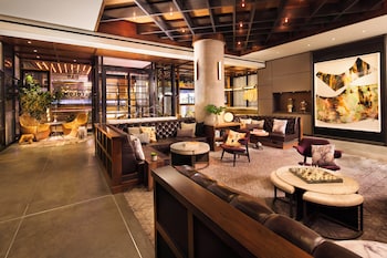 A modern building with a glass facade, a reception area, and a bar. at Kimpton Hotel Eventi by IHG