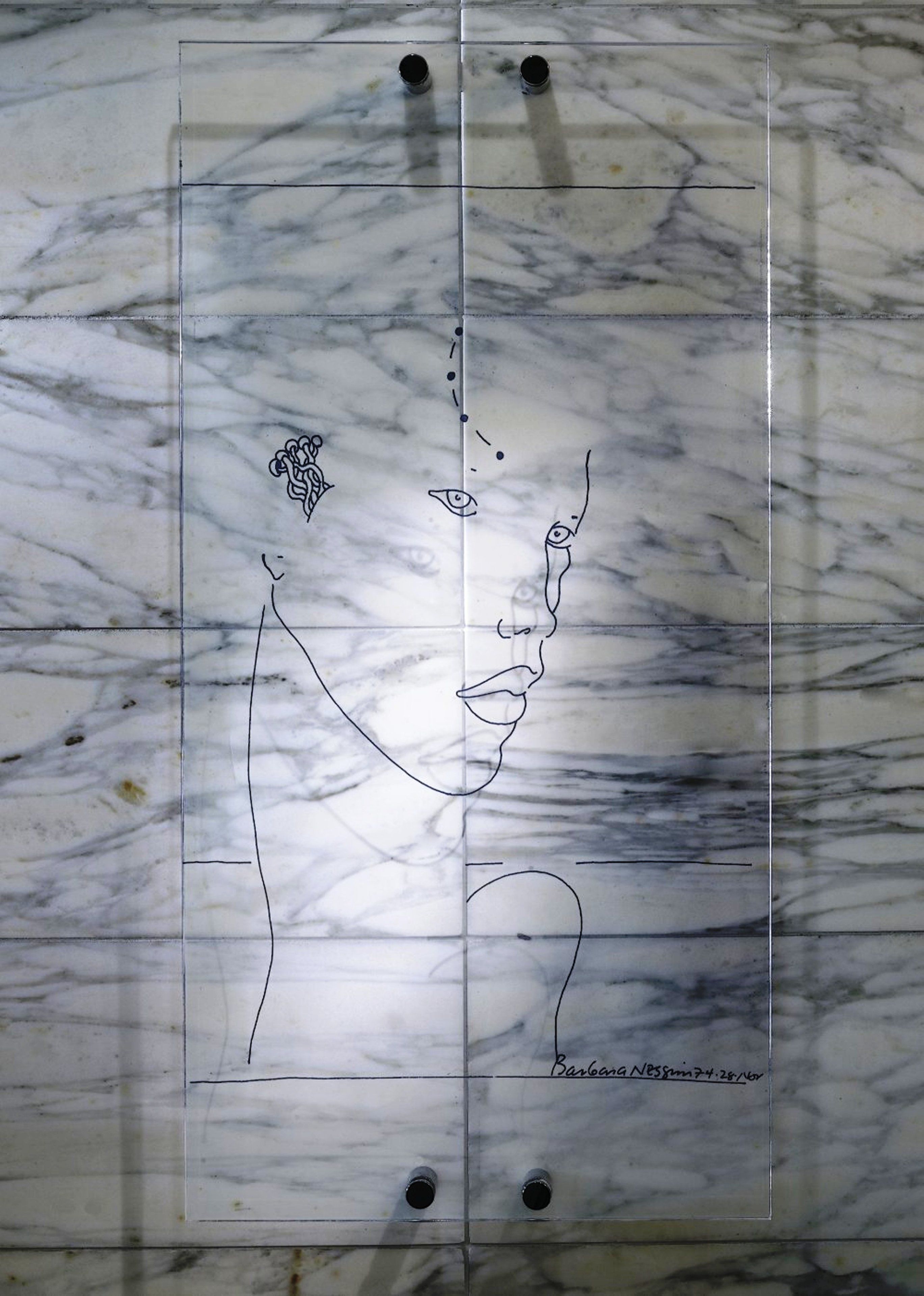 A marble floor with a clear plastic sheet featuring a line drawing of a person and a snake.