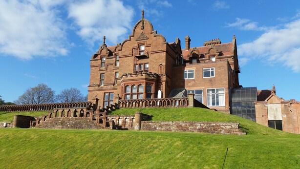 A large, historic building with multiple stories, a prominent entrance with steps, and a surrounding garden. - Adamton Country House Hotel (Prestwick)