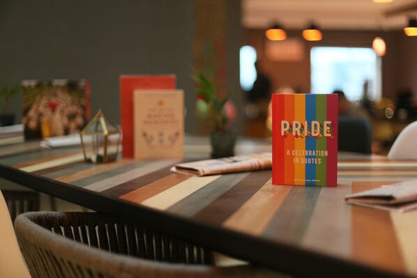A book titled "Pride: A Celebration in Quotes" on a table.