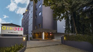 A modern building with a sign reading "GINGER An IHCL Brand" at the entrance. - Ginger Pune Wakad (Paud)