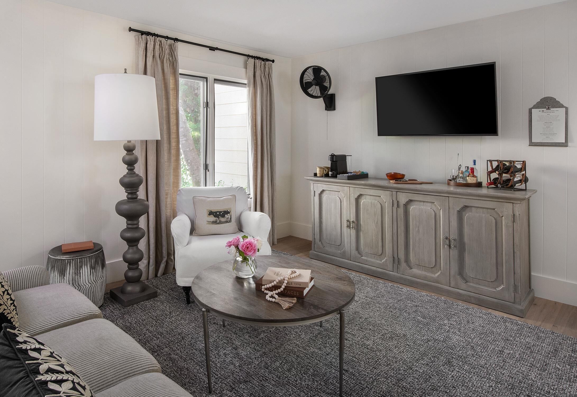 A living room with a sofa, a coffee table, a lamp, a TV, and a cabinet.