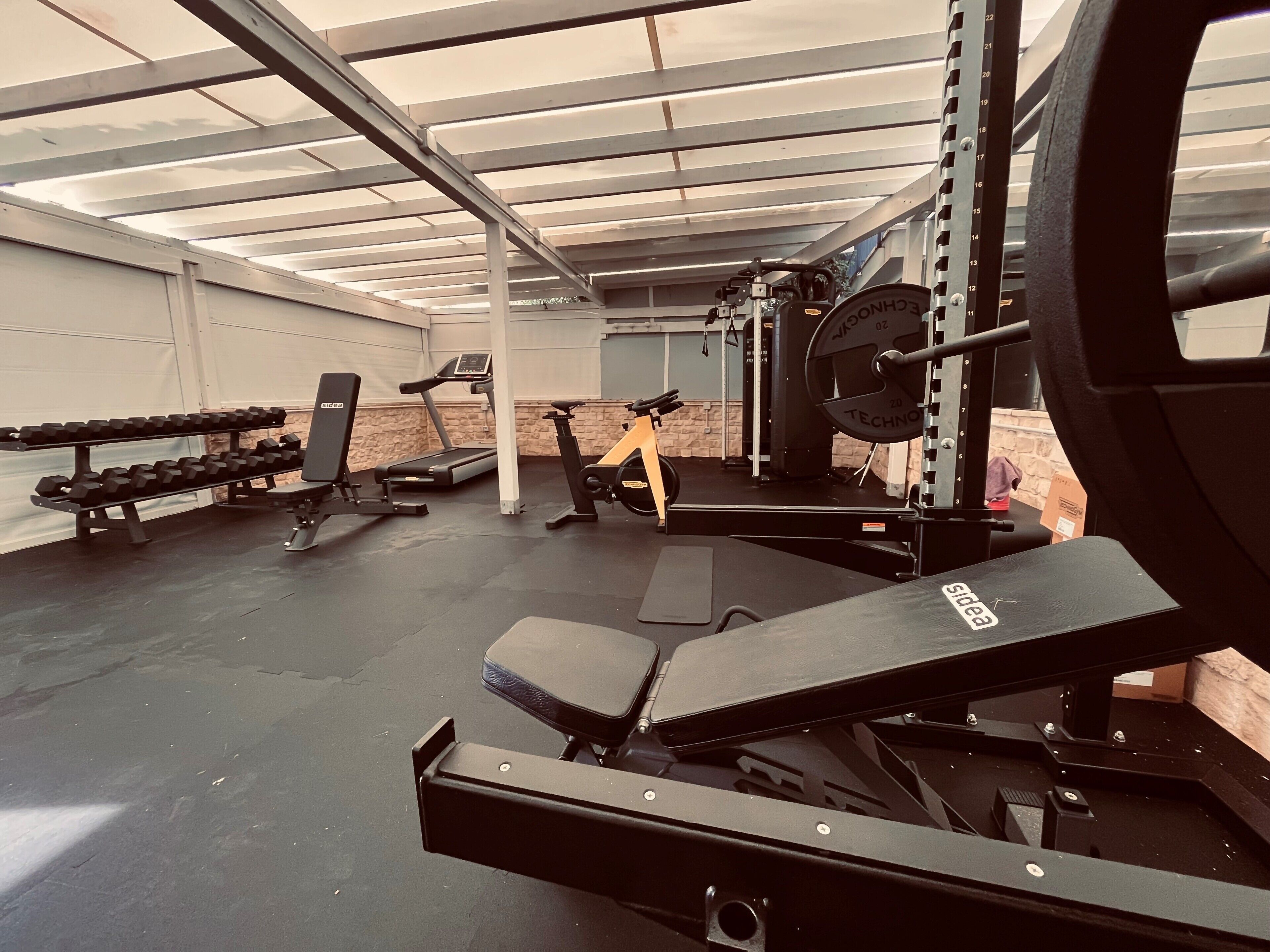 A gym with weightlifting equipment, treadmills, and exercise machines.