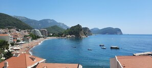 A coastal town with a beach, boats, and mountainous backdrop. - Monte Casa Spa & Wellness (Petrovac)
