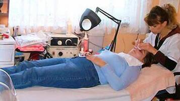 Medical professionals attend to patients in this well-equipped examination room.