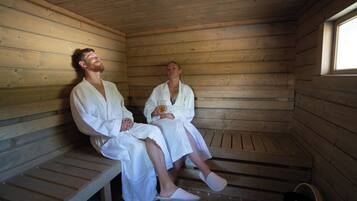 Relax in a serene sauna room with comfortable seating and a calming atmosphere.