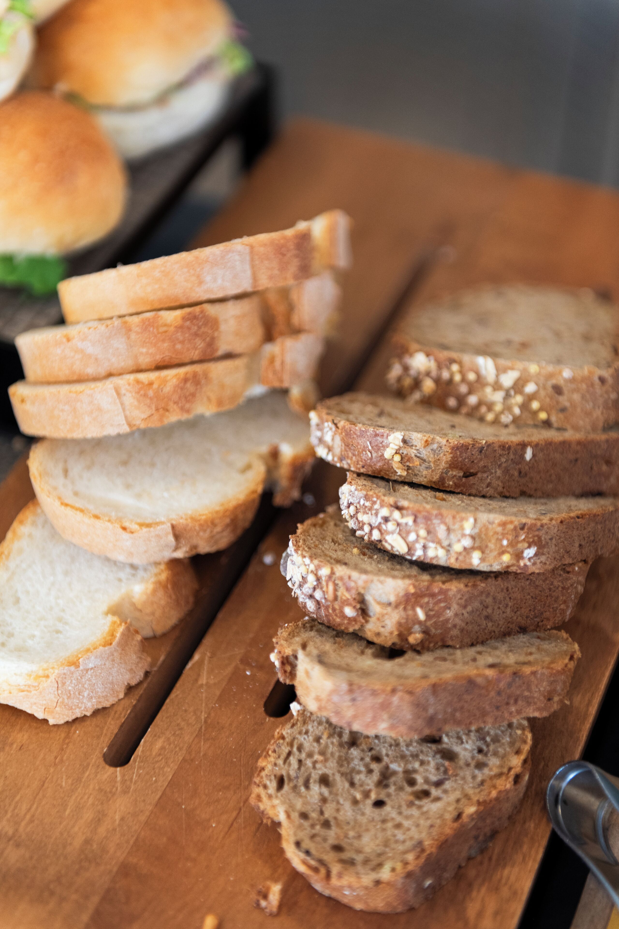 Slices of bread on a wooden cutting board.
