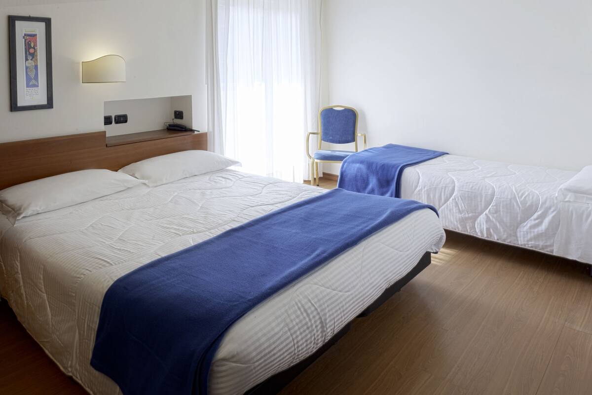 Economy Triple Room, Multiple Beds | Premium bedding, minibar, in-room safe, desk