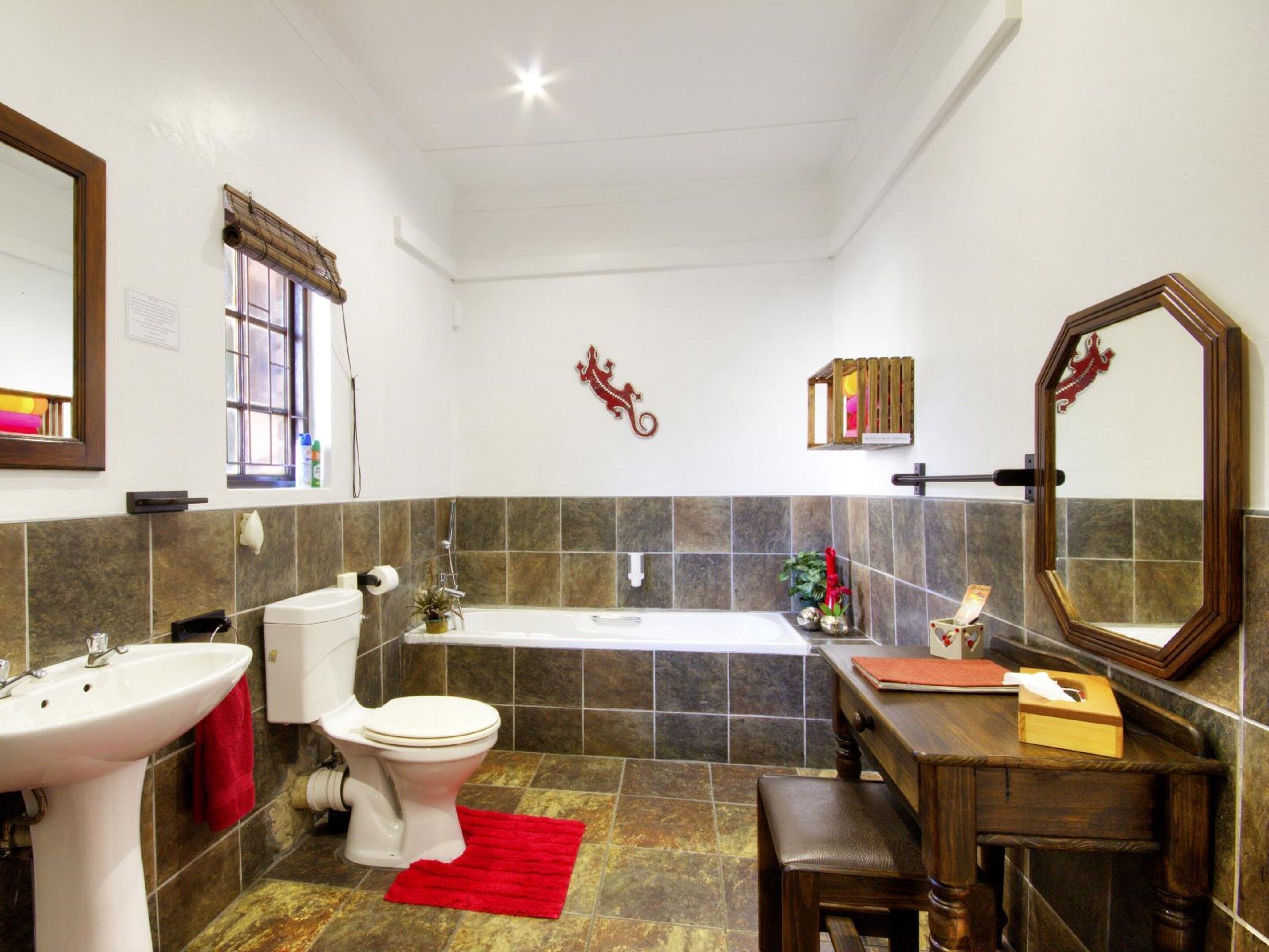 A bathroom with a toilet, sink, and bathtub.