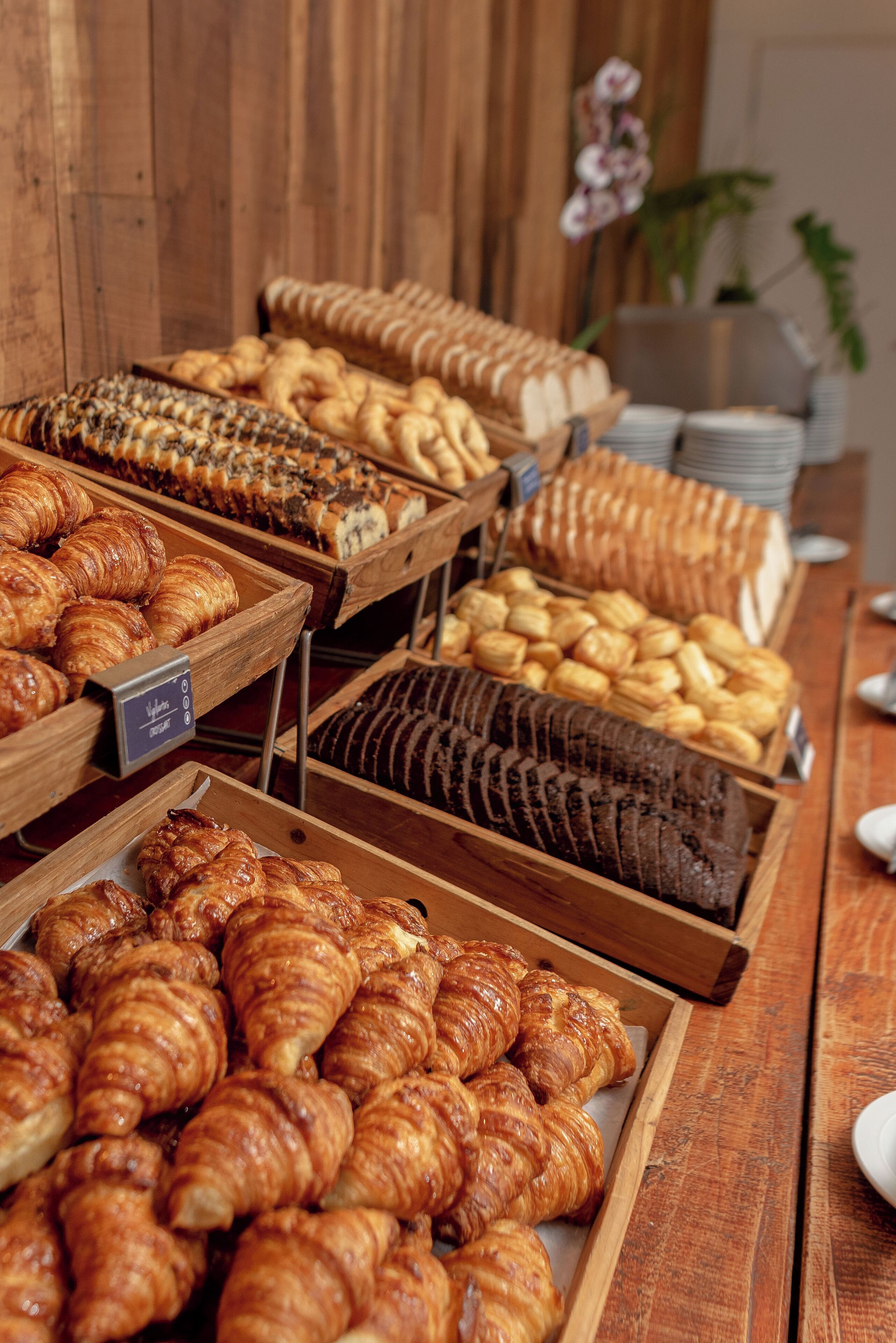A bakery display with various baked goods like croissants and bread.