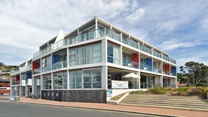 A multi-story building with a modern architectural design, featuring large windows and balconies. - Hotel St Clair (Dunedin)
