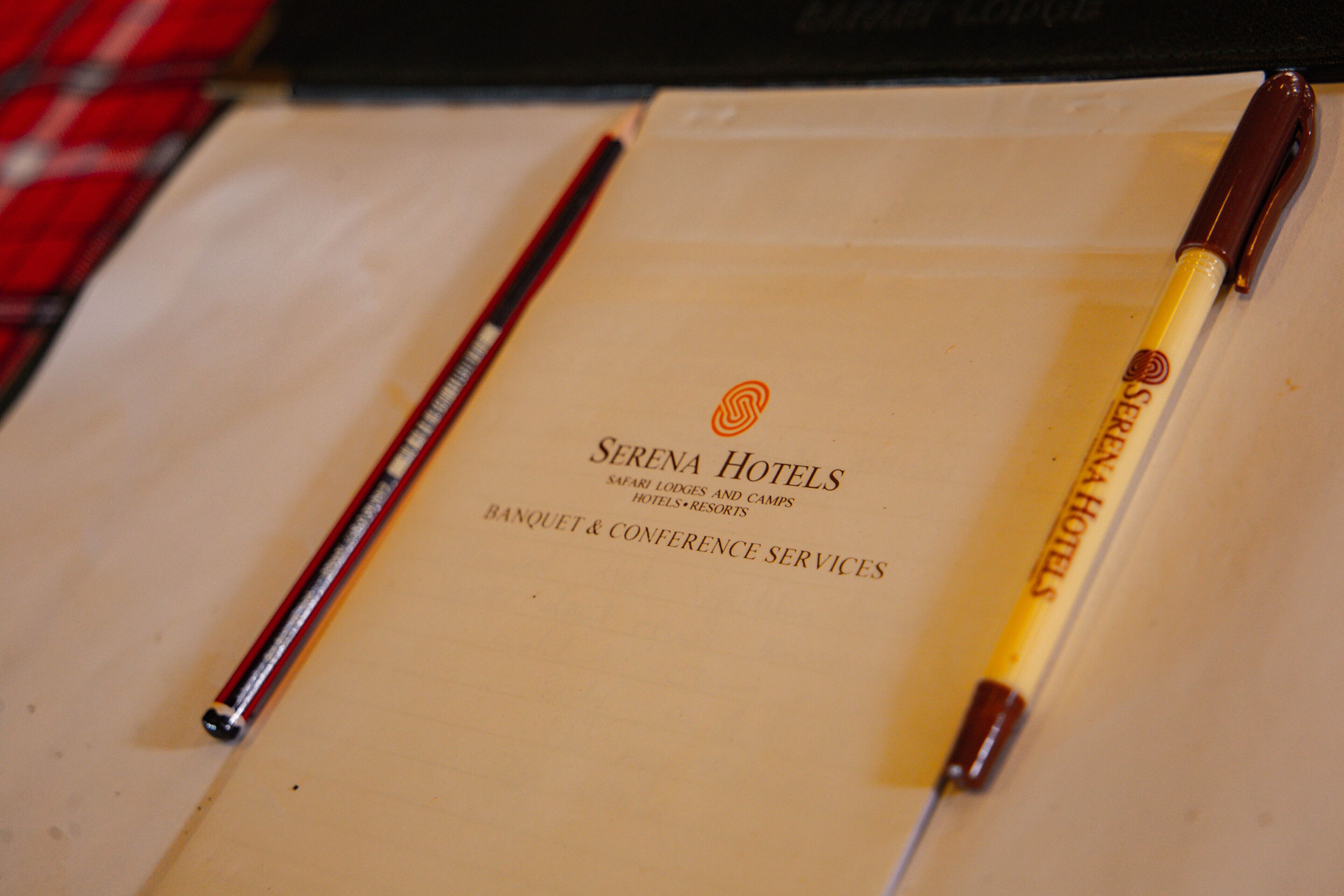 A brochure for Serena Hotels, highlighting their safari lodges, camps, and banquet & conference services.