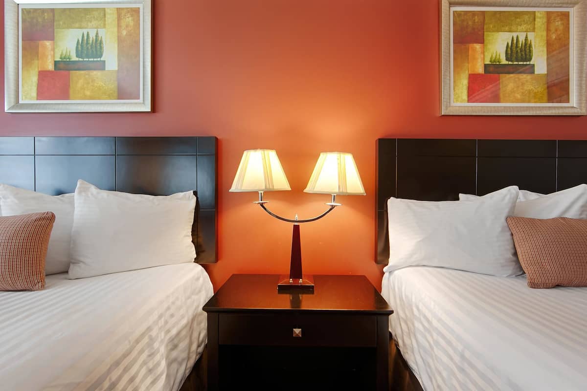 standard room, 2 queen beds, non smoking, refrigerator & microwave | in-room safe, desk, iron/ironing board, wifi