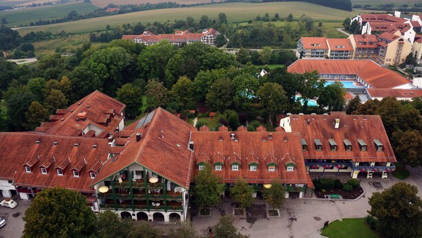 A large hotel with multiple buildings, red-tiled roofs, and a swimming pool. - Sonnleiten-Rupert - Aparthotel (Bad Griesbach im Rottal)