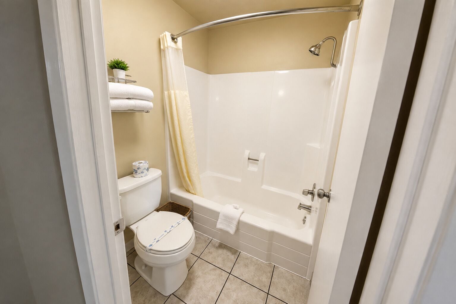 A bathroom with a toilet, a shower, and a bathtub.