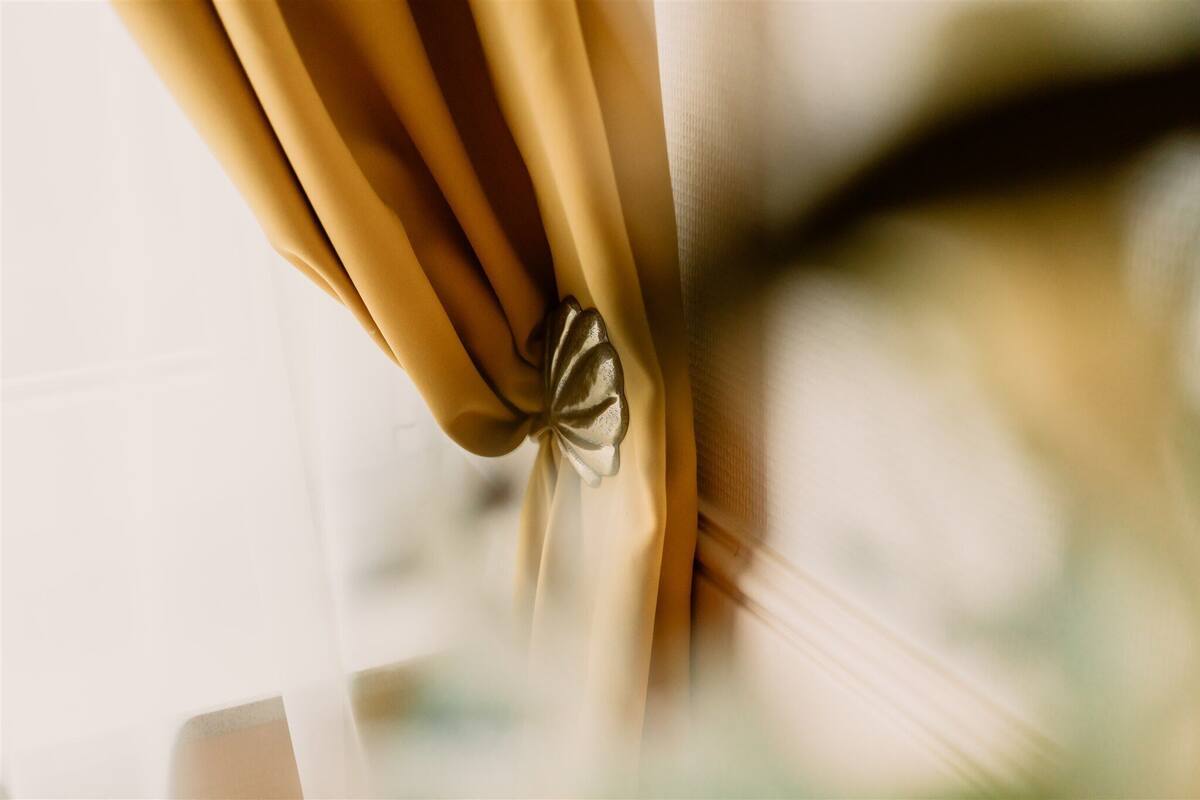 A close-up of a curtain tied with a bow.