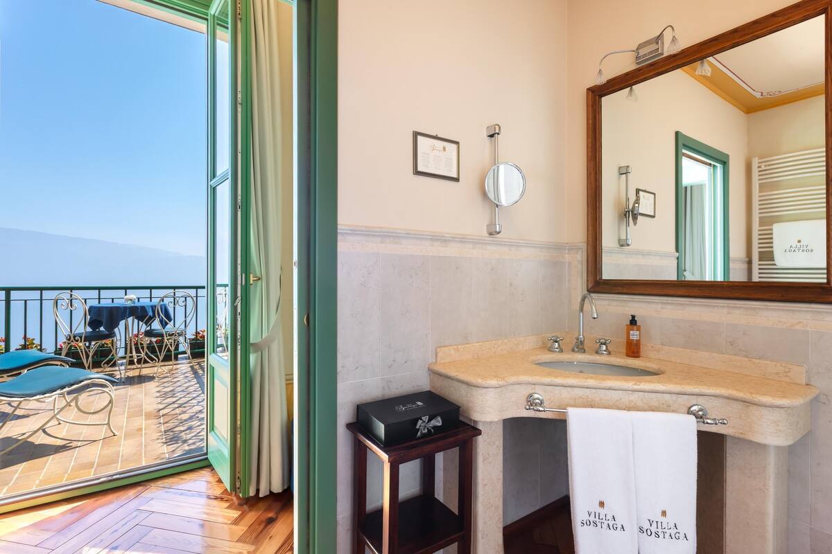 signature room villa with terrace and lake view | bathroom | shower, free toiletries, hair dryer, bathrobes