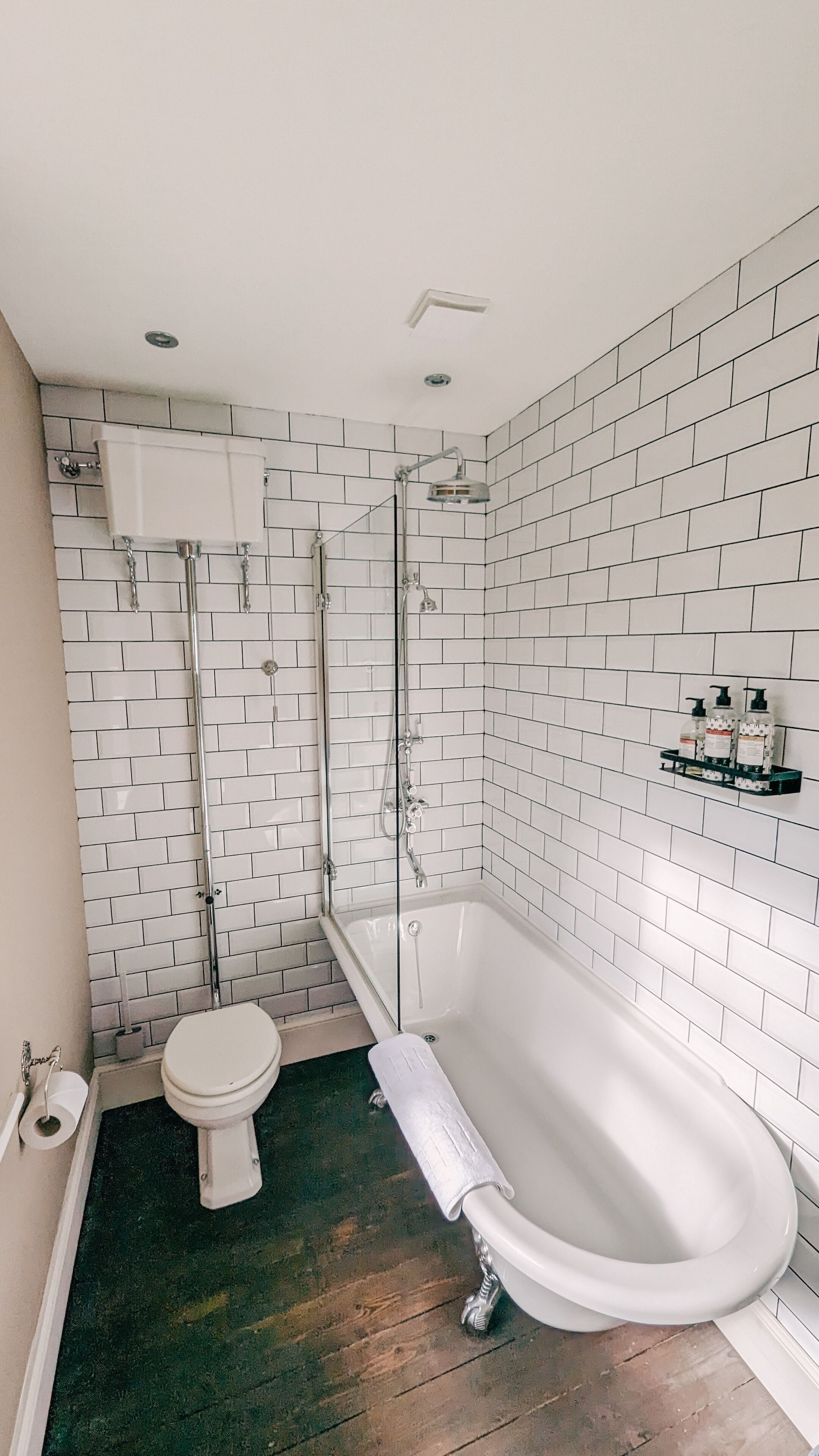 Un baño con una bañera blanca, un inodoro y una ducha.