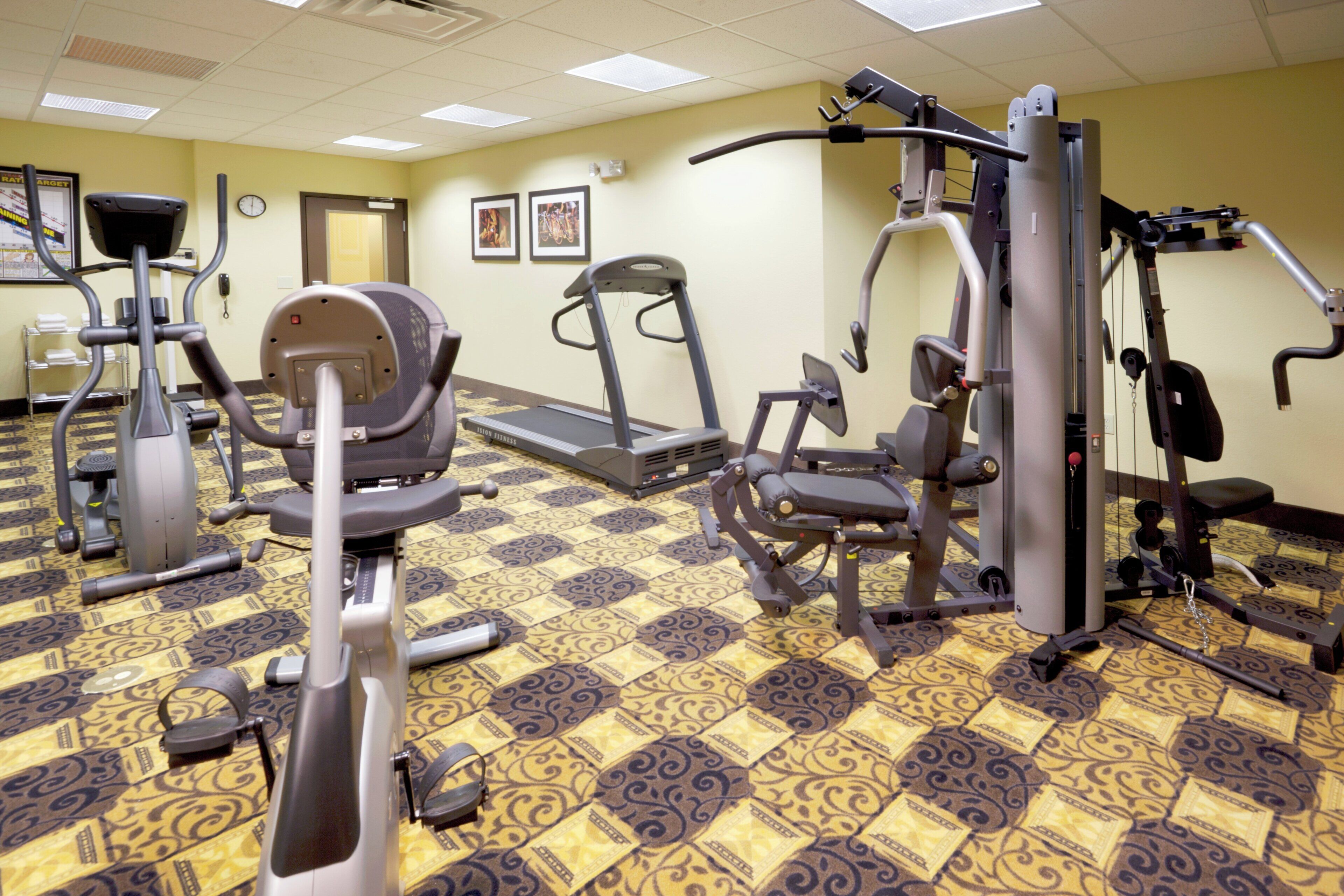 A fitness center with treadmills, elliptical machines, and weight equipment.