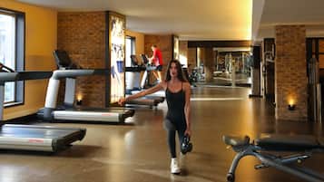 A gym with treadmills, a stationary bike, and a kettlebell.