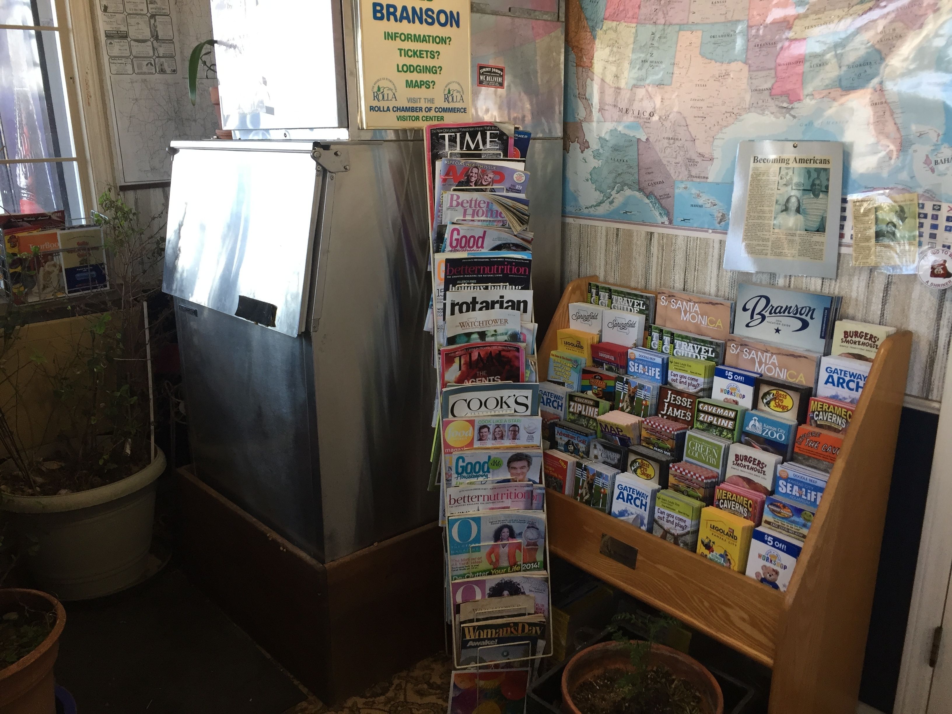 A bookstore with a variety of books and magazines, a map on the wall, and a sign for Branson information.
