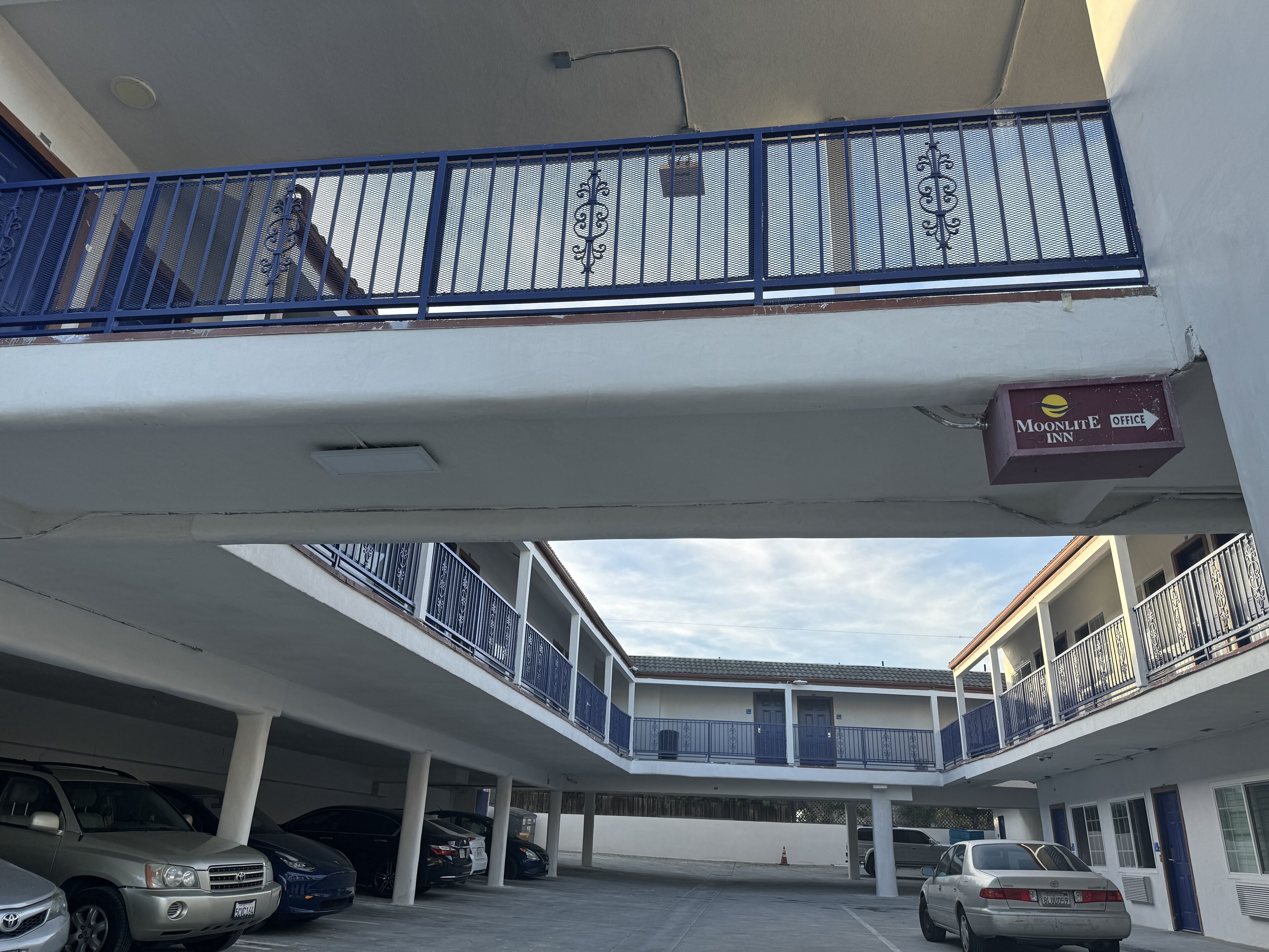 A multi-level parking structure with several cars parked.