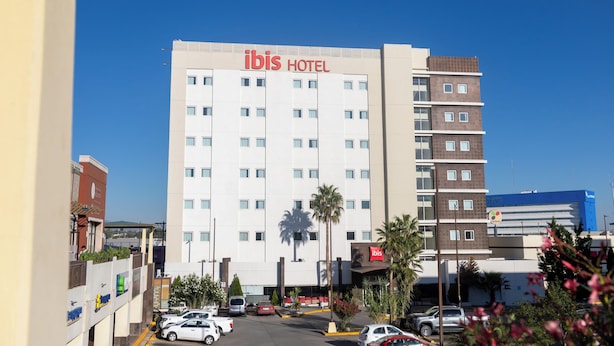 A multi-story hotel with a prominent "ibis HOTEL" sign.