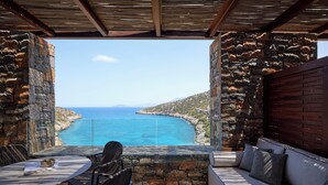 A stone-walled outdoor seating area with a view of the sea. - Daios Cove (Agios Nikolaos)