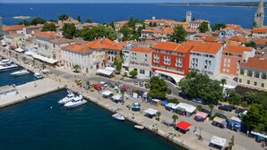 A coastal town with historic buildings, a marina, and a prominent church tower. - Valamar Riviera Hotel & Residence (Porec)