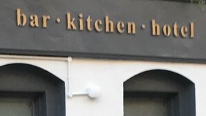 A building with a sign that reads "bar, kitchen, hotel". - Rab Ha's (Glasgow)