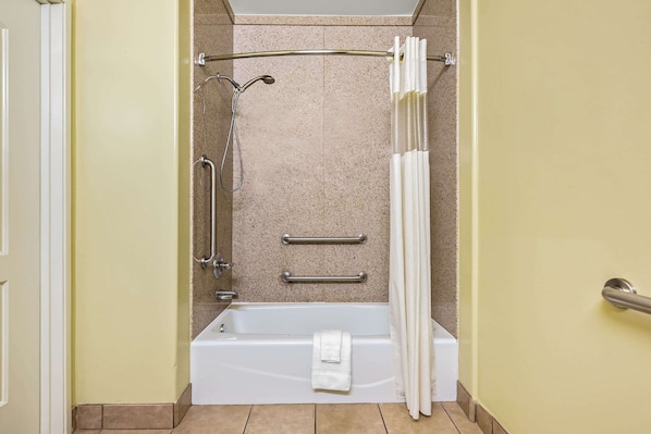 A bathroom with a bathtub, a shower, and a toilet.