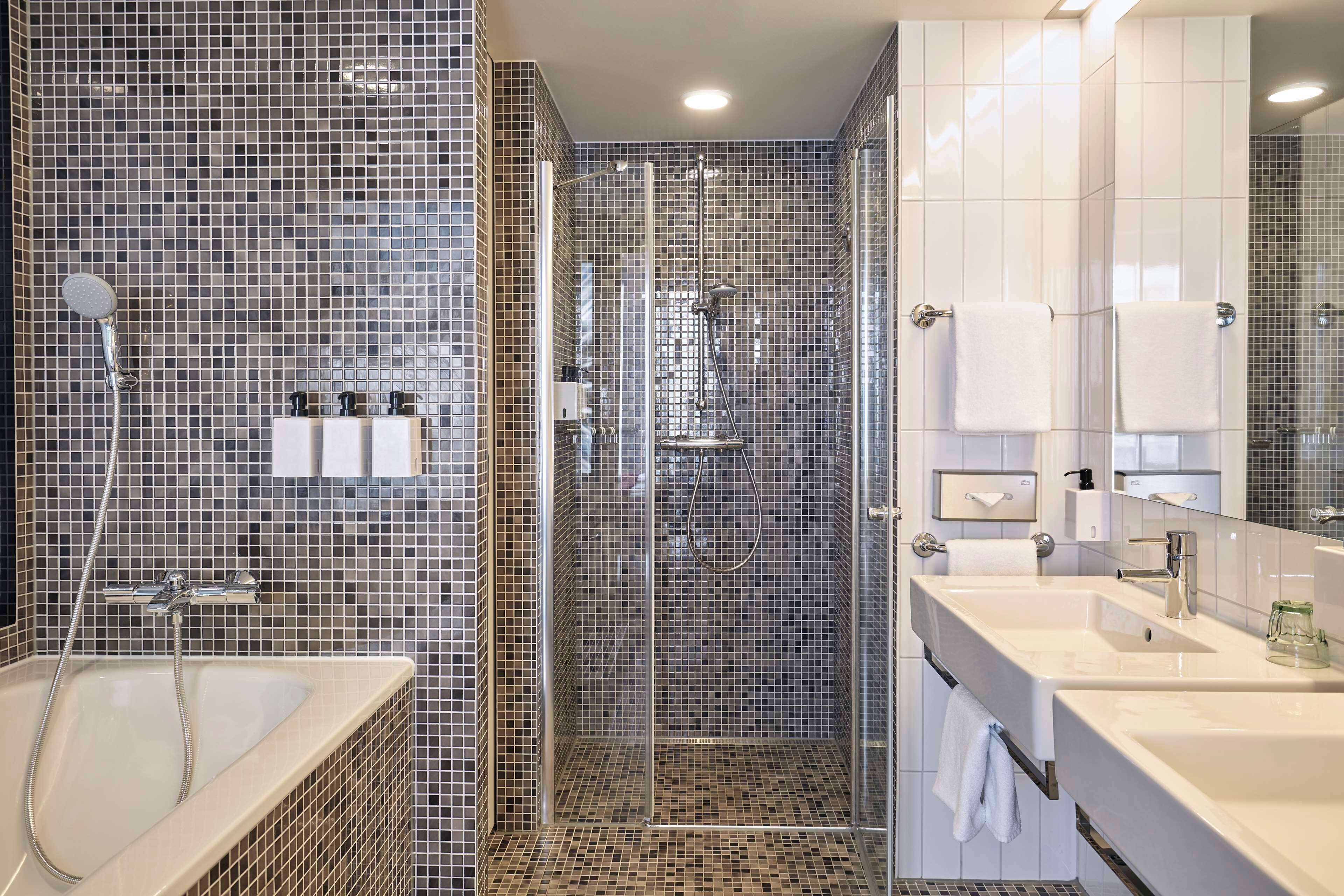 junior suite | bathroom | shower, eco-friendly toiletries, hair dryer, towels